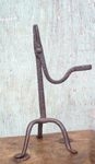 A 17TH CENTURY IRON RUSHNIP ON A TRIPOD BASE