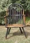 A sculptural 18th century ash and elm primitive hoop back chair with original green paint