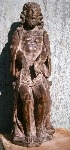 A mid 16th century carved oak figure of Christ seated on the cold stone