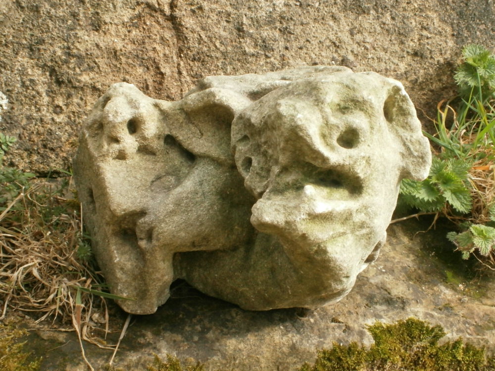 An English Medieval Carved Stone Grotesque Of A Howling Dog.