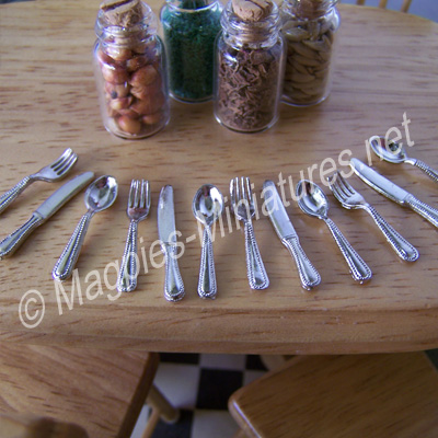 Silver coloured cutlery - 4 place settings