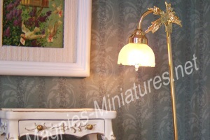 A miniature dollshouse working floor lamp next to a table and picture all in 12th scale