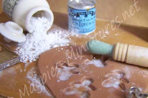 A model scene of gingerbread being made and flour split on the table