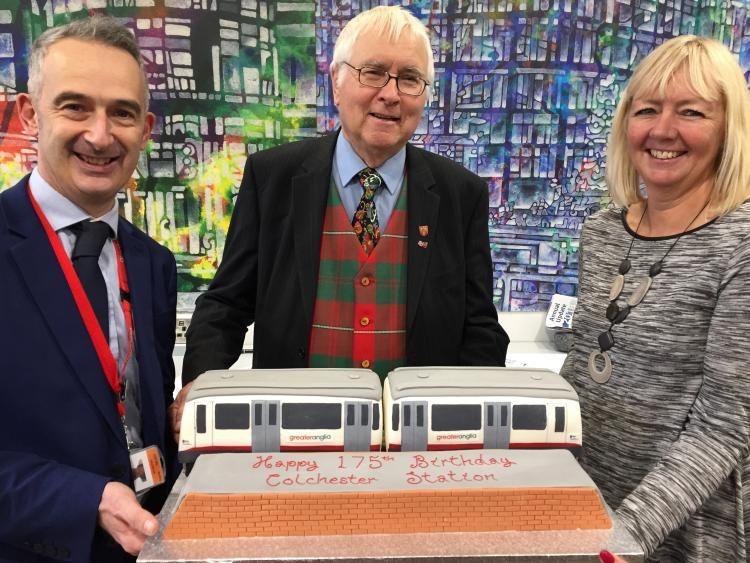 Dignitaries posing with 175th anniversary train shaped birthday cake