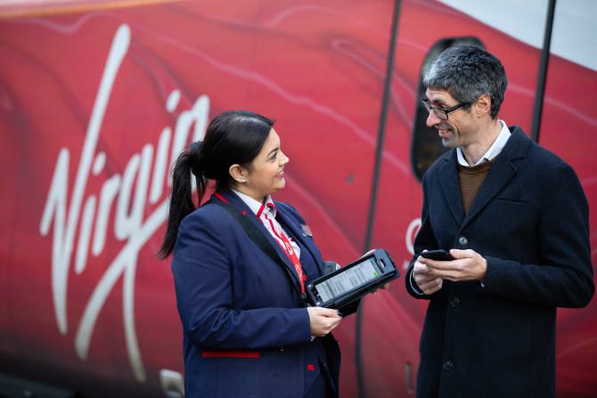 Virgin Trains staff holding new handheld devices