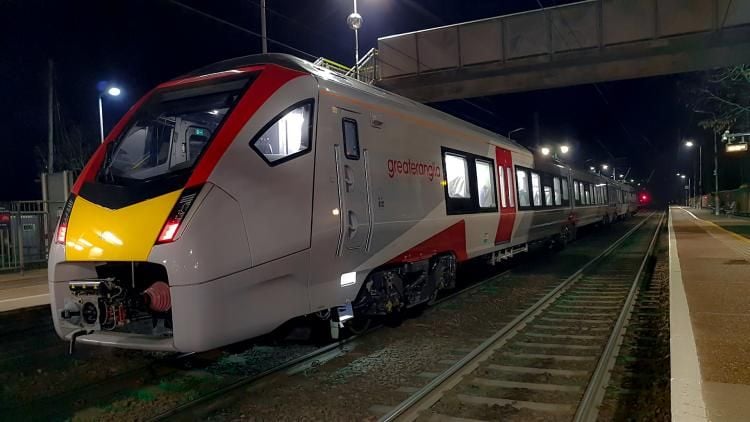 New Greater Anglia train passing station at night