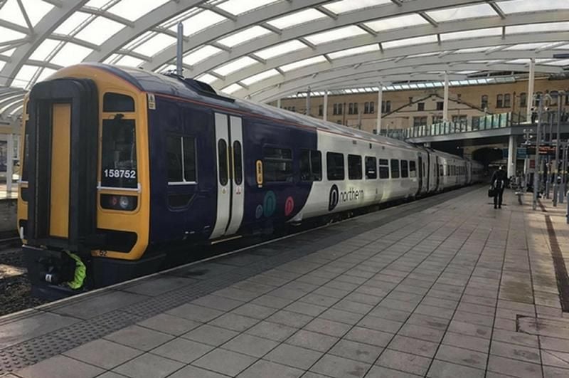 Northern Class 158 stands at a railway station