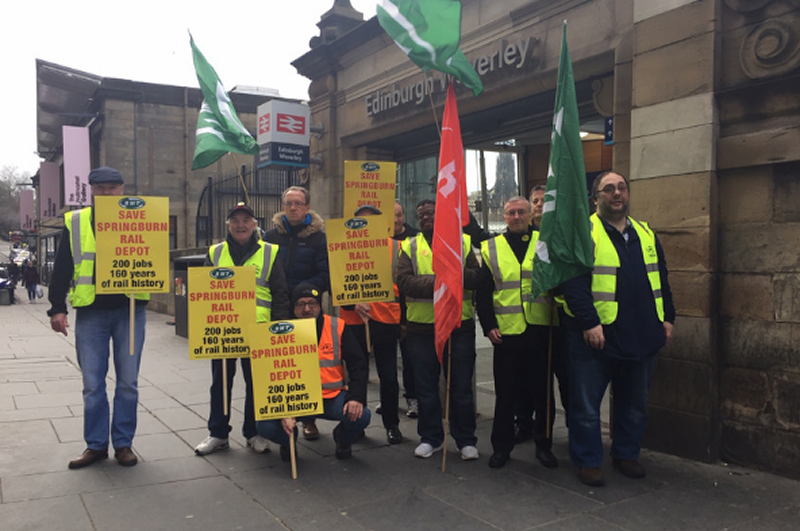 RMT members stage protest outside Edinburgh Waverley station.