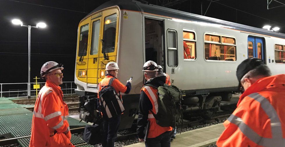 Engineers stand around a Class 319 EMU