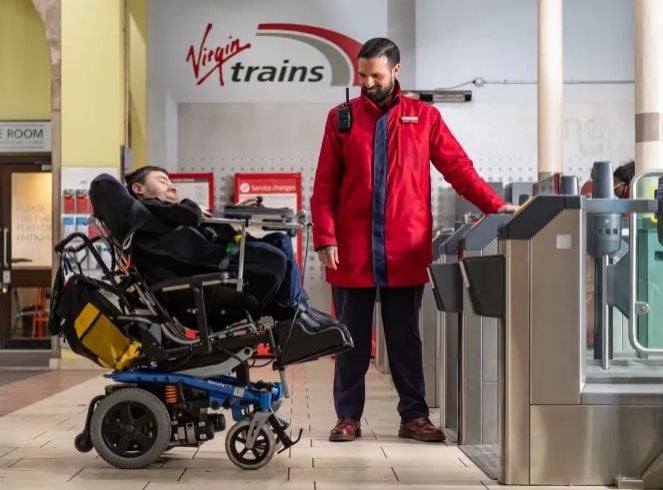 Image showing Virgin employee assisting disabled customer