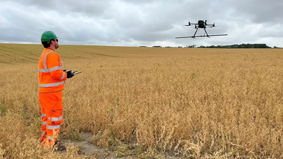 Image showing a worker surveying the area on the East West Rail project