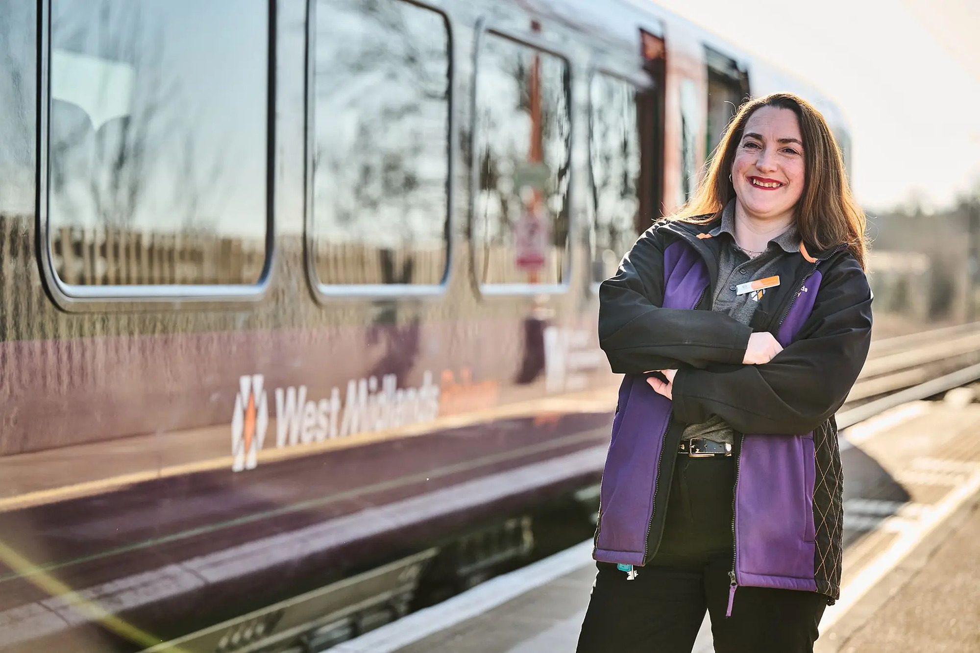 Image showing a West Midlands Railway employee stood alongside one of their trains