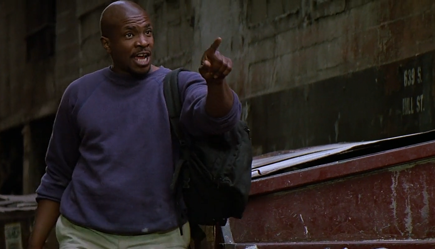 Frank Armitage reacting in shock as John Nada tells him to wear the special sunglasses in They Live