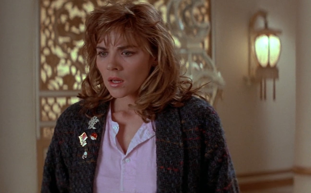 Image shows Gracie Law looking confused, as the villain Lo Pan steps into the doorway