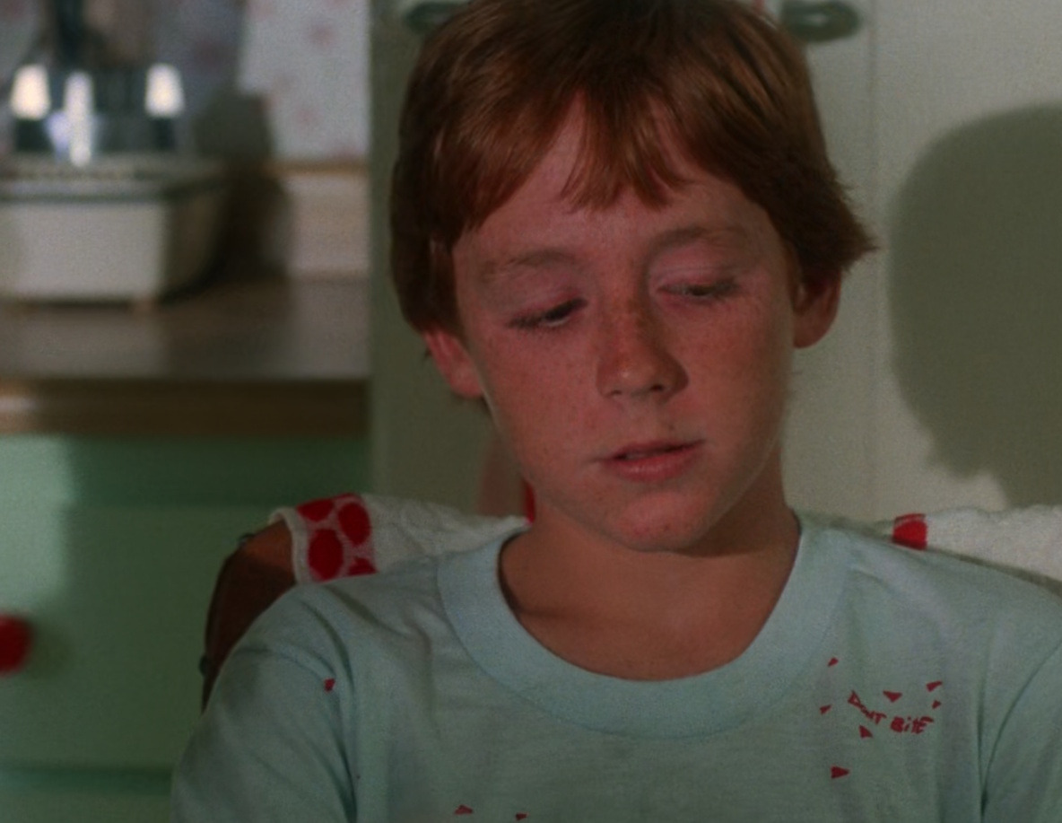 Brad Brown sitting at the breakfast table in a scene from Critters (1986)