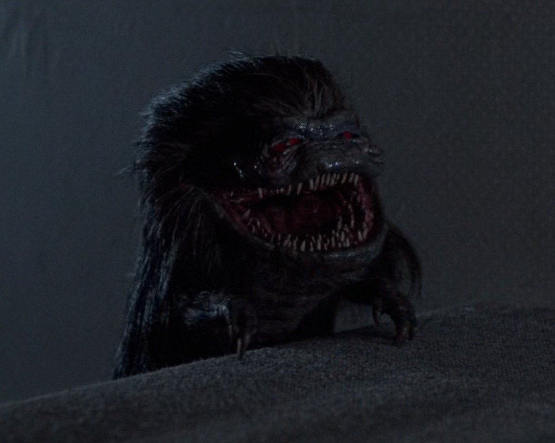 A Critter perched at the top of the stairs in a scene from Critters (1986)