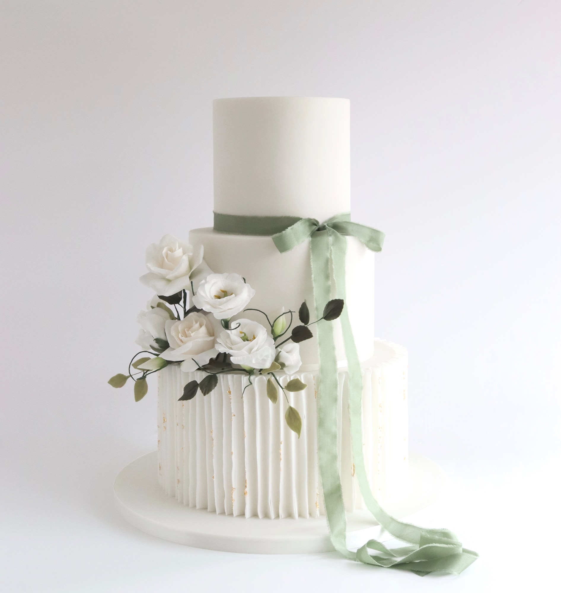Sage green wedding cake with gold
