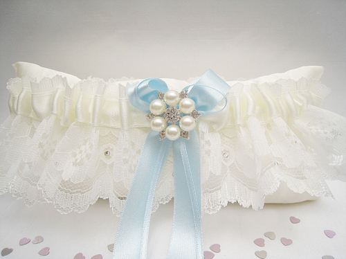 Lace wedding garter with hand tied blue bows