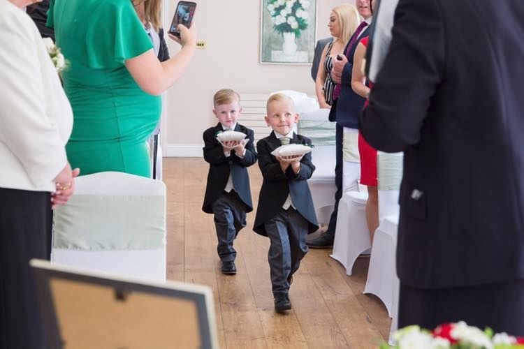 Page Boys Each Carrying A wedding Ring Cushion