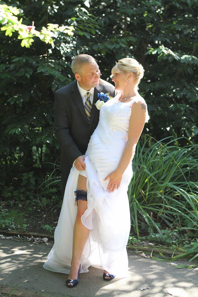 Bride Showing off her wedding garter to her new husband.
