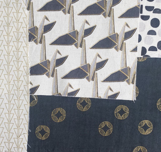 Ellen Luckett Baker Monochrome paper cranes in natural and gold 