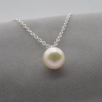 White pearl pendant on a delicate silver or gold chain. 11-12 mm