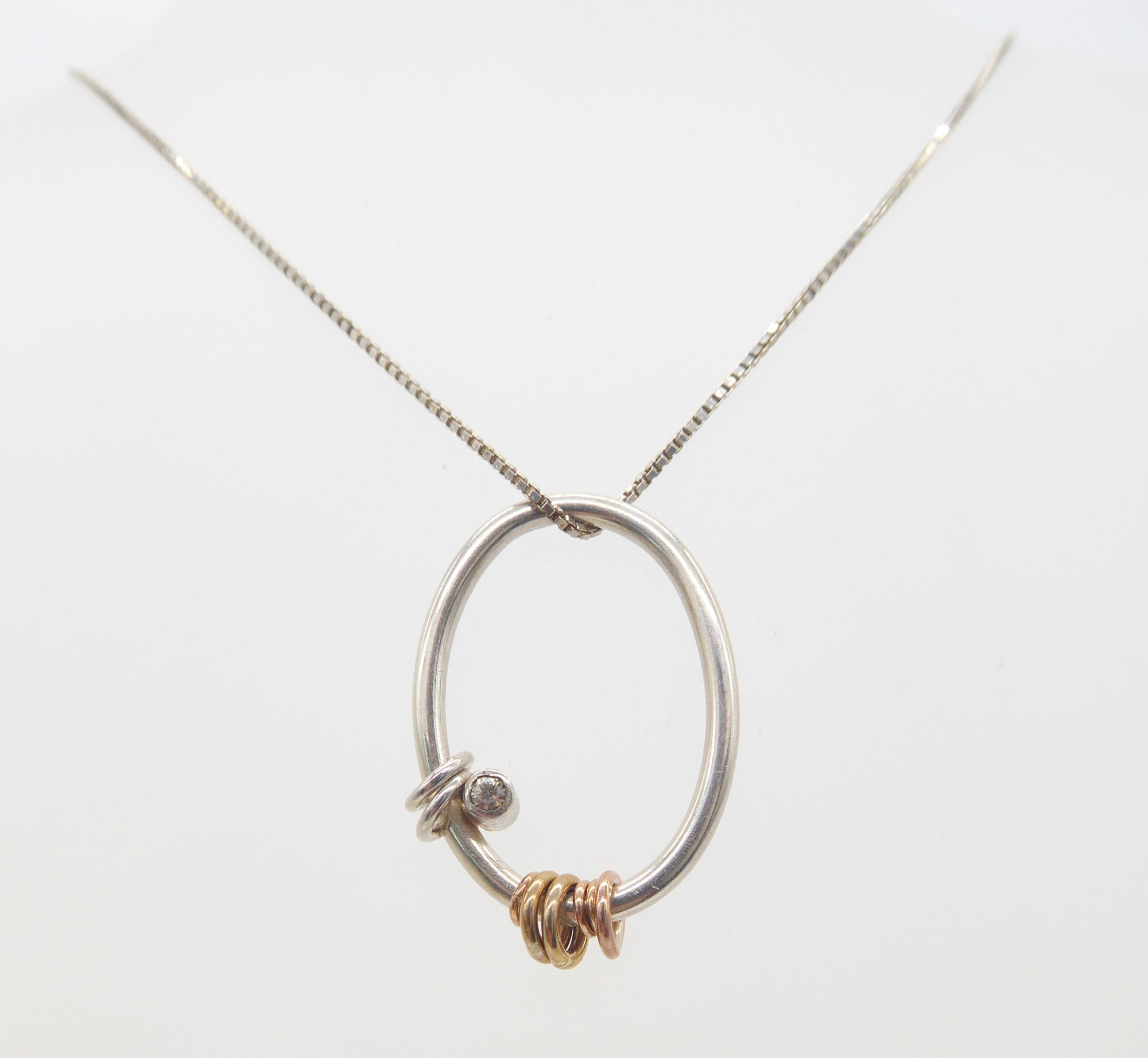 silver and gold loop pendant