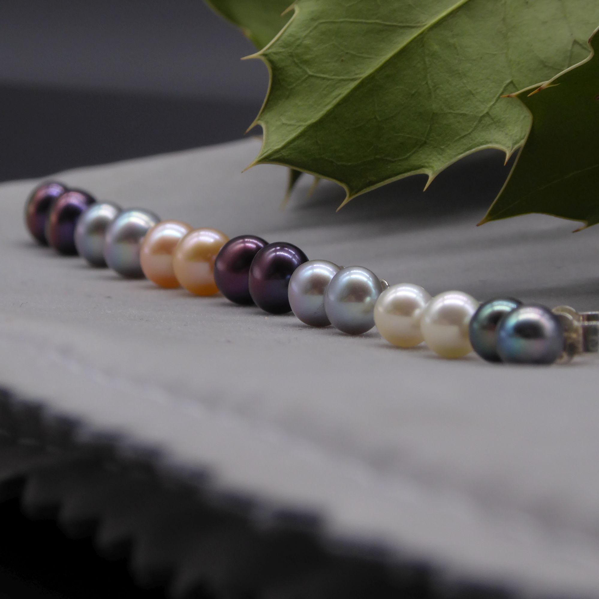 Multicoloured row of pearl stud earrings
