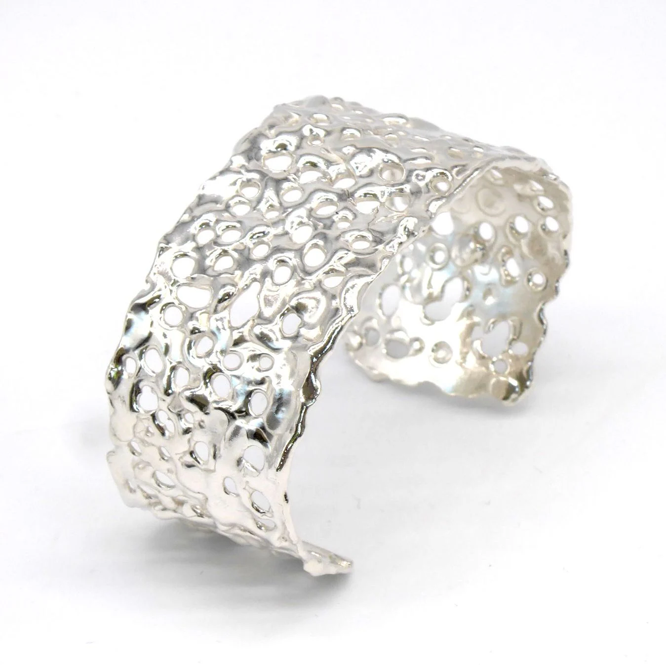 Hand carved silver cuff with organic hole pattern