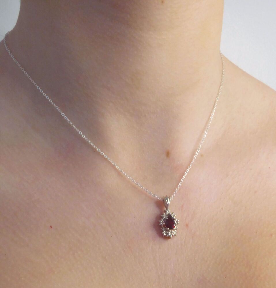 Fleur - Delicate Flower Patterned Silver Pendant Set With A Pear Shaped Garnet Gemstone