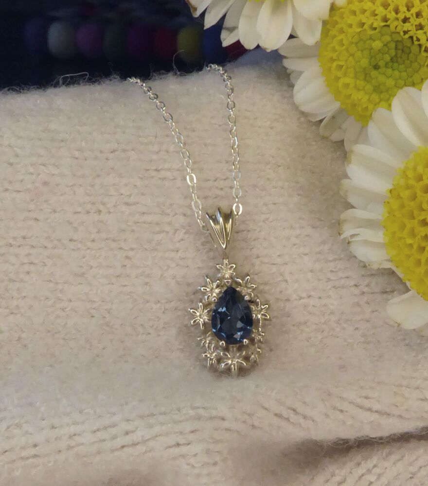 Fleur - Delicate Flower Patterned Silver Pendant Set With A Pear Shaped London Blue Topaz Gemstone