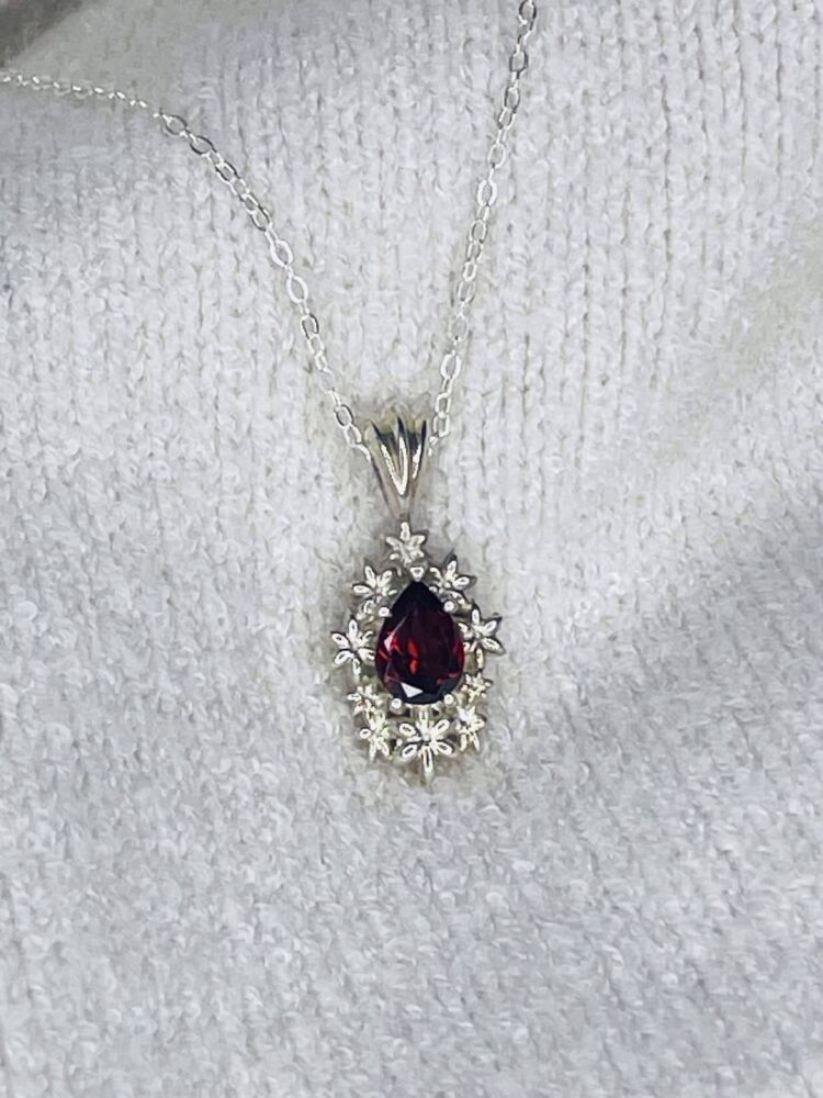 Fleur - Delicate Flower Patterned Silver Pendant Set With A Pear Shaped Garnet Gemstone