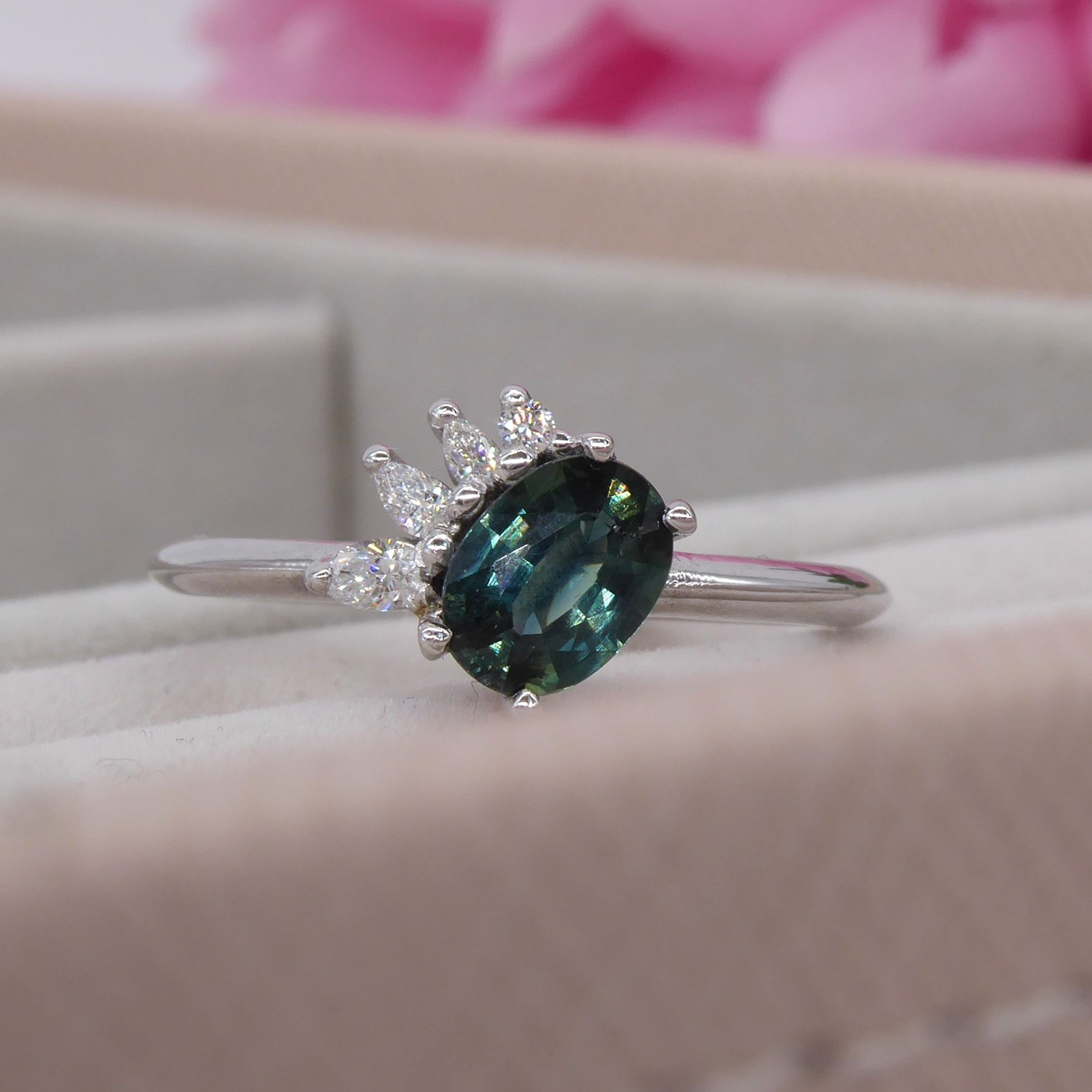 Oval teal sapphire asymmetrical white gold engagement ring