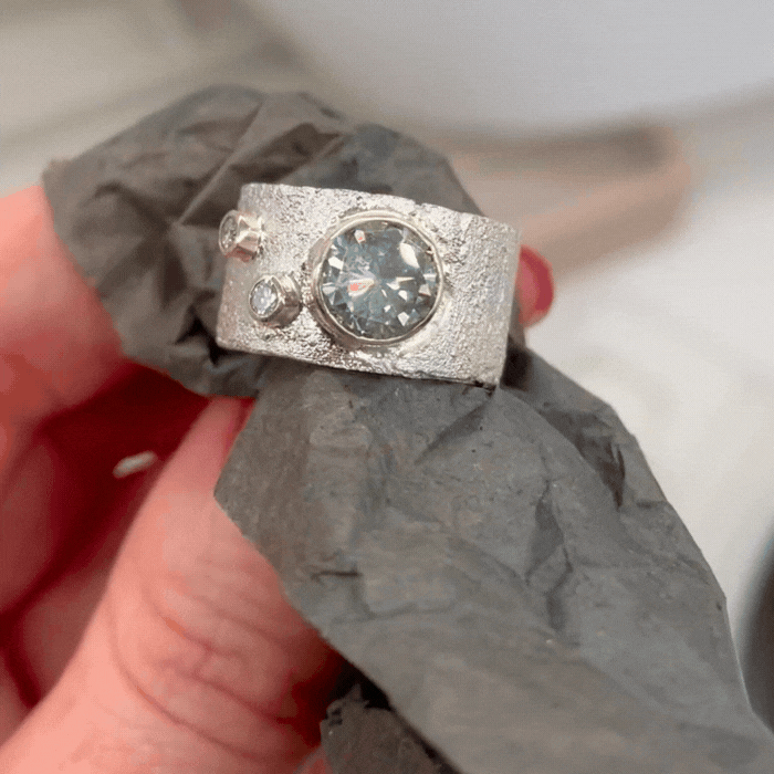 Moissanite and Diamond Textured Silver Ring With Gold Detail