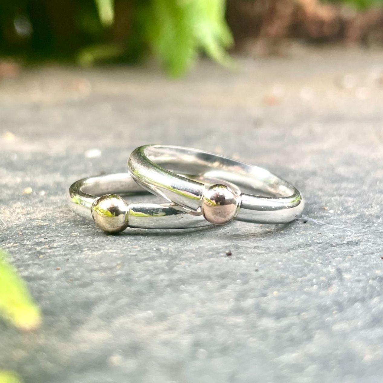 Handmade silver with gold ball detail in a tension set style