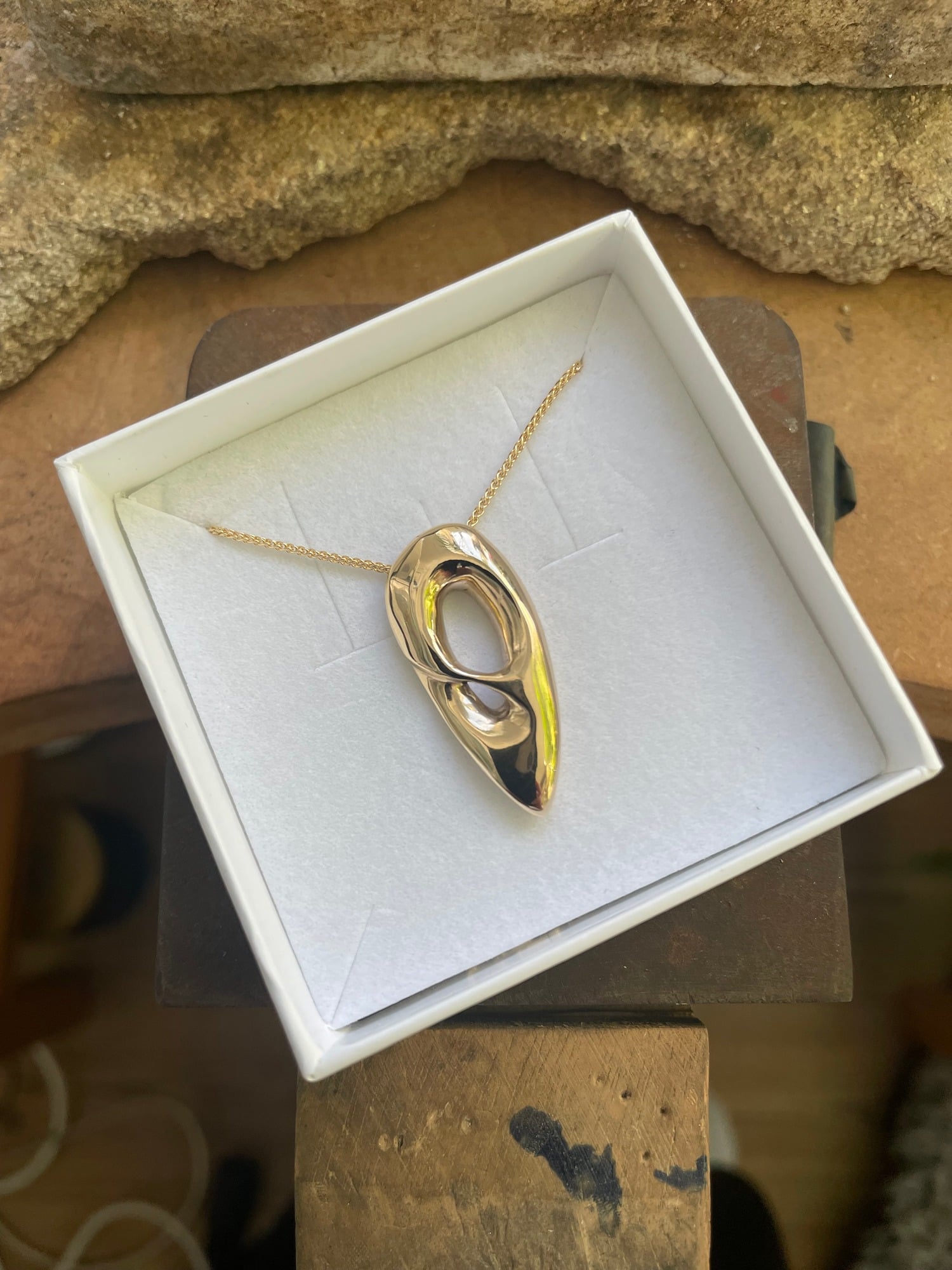 The finished bespoke gold pendant carved from wax