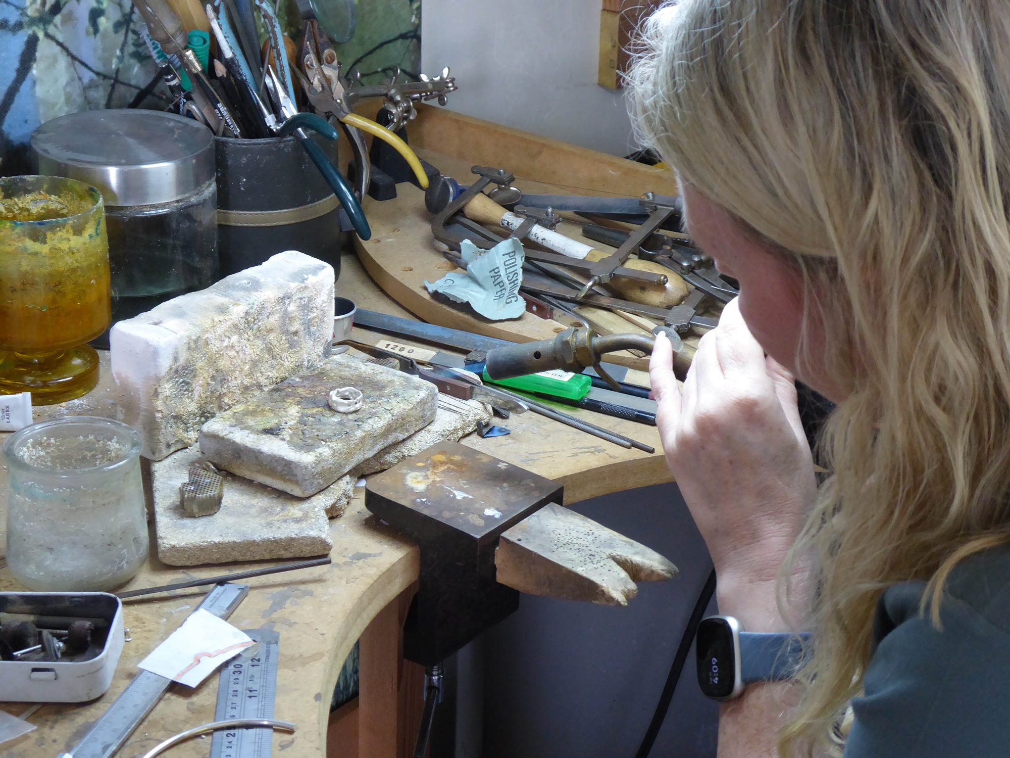 Nikki Galloway - Contemporary jeweller working at the bench in a Surrey studio, hand-finishing a unique silver and gold jewellery commission.