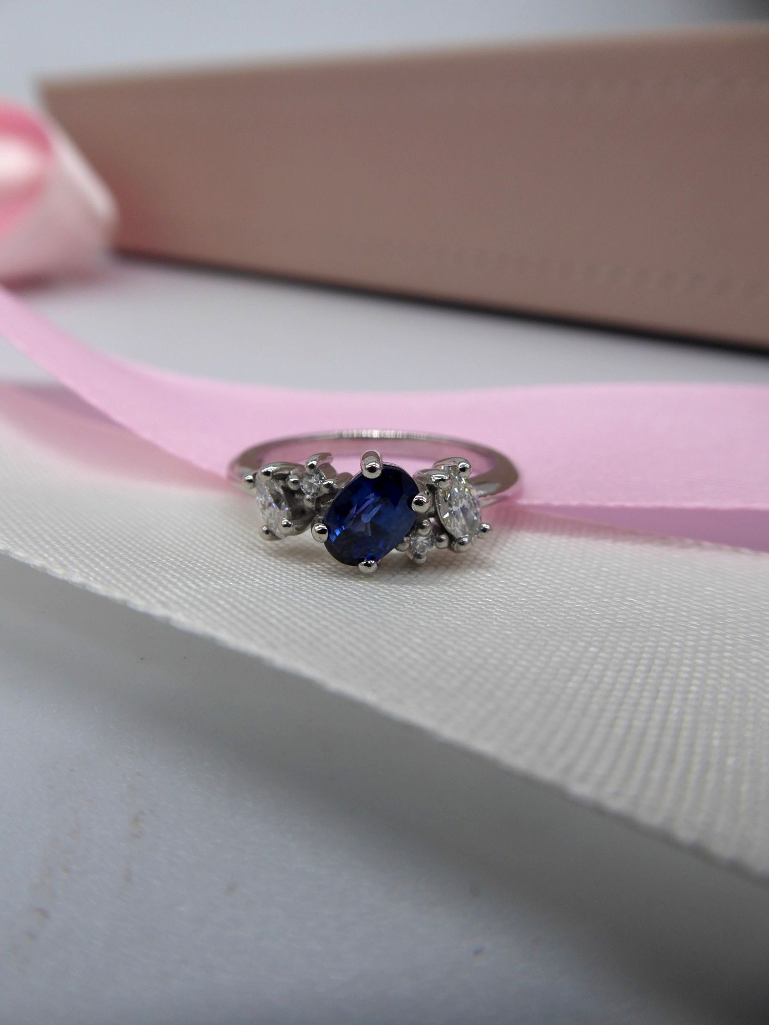 Bespoke Atlantis sapphire and diamond asymmetrical engagement ring in platinum, made in Surrey.