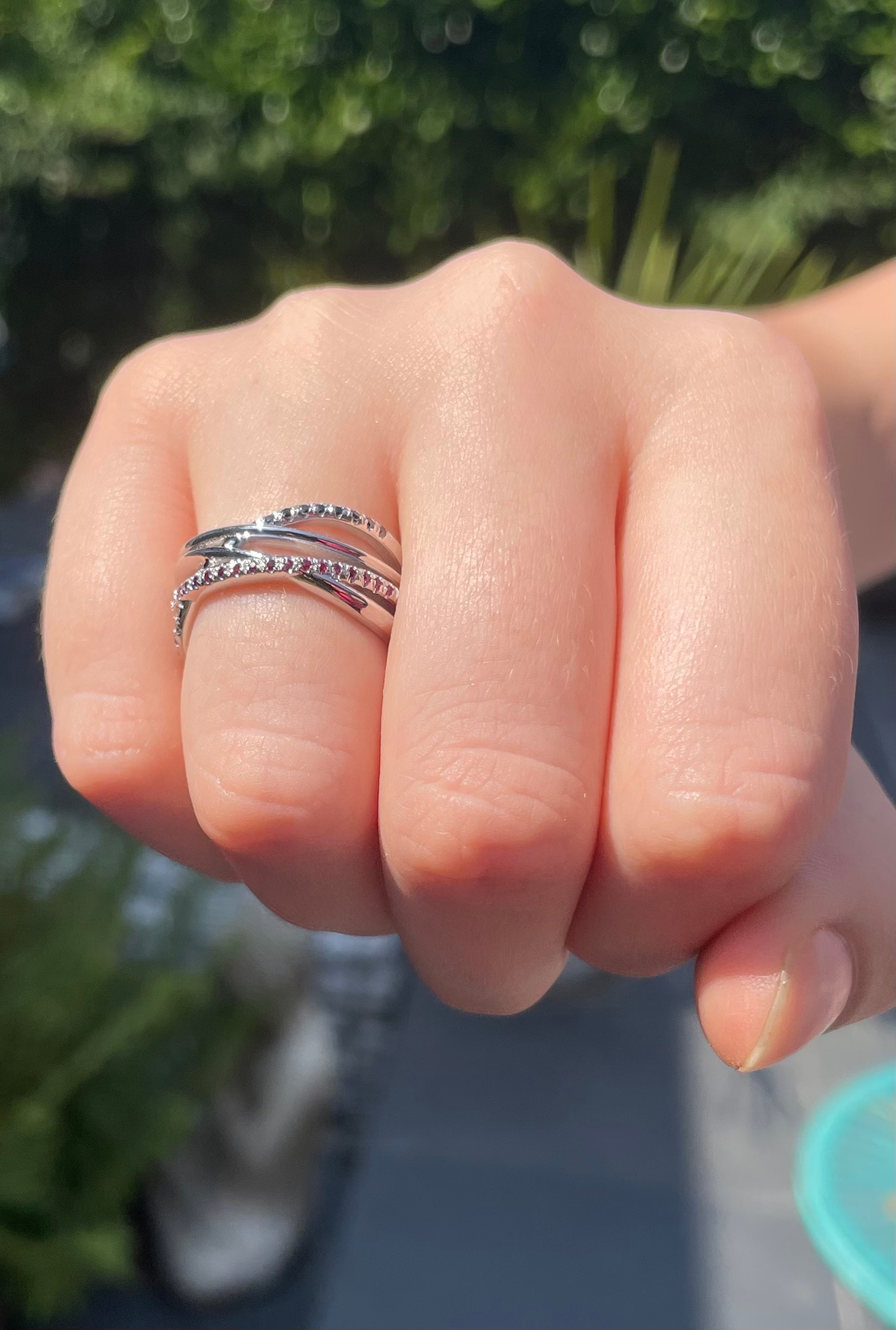 Eternal Infinity ruby and black diamond white gold eternity ring with sculptural woven design.
