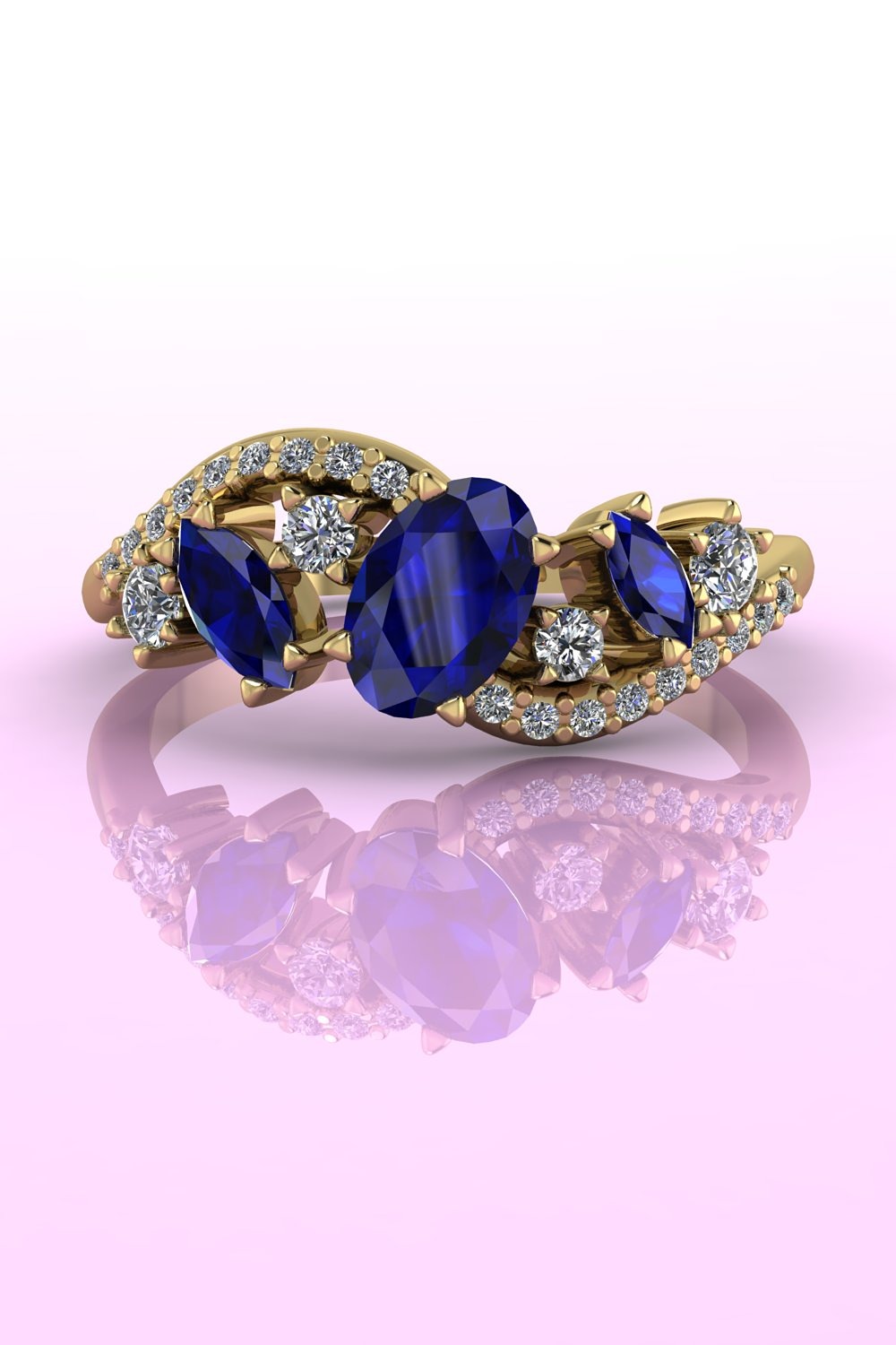 An asymmetrical sapphire and diamond cluster engagement ring set in yellow gold