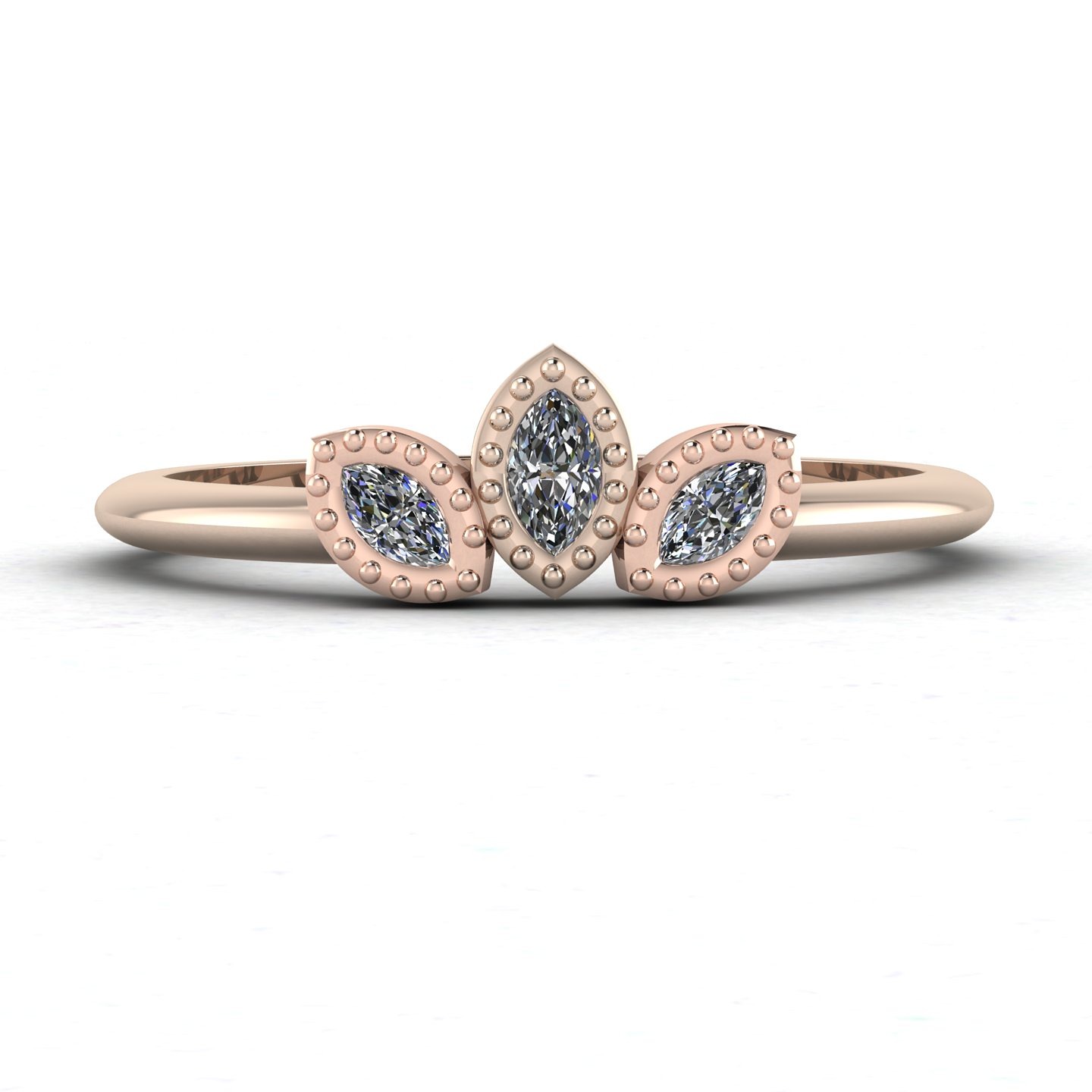 The Astraea - a dainty wedding or engagement ring featuring three dainty marquise diamonds set in rose gold
