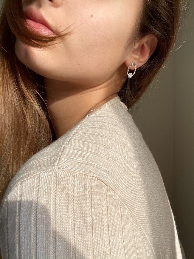 Handcrafted silver Rose Thorn stud earrings on model side view