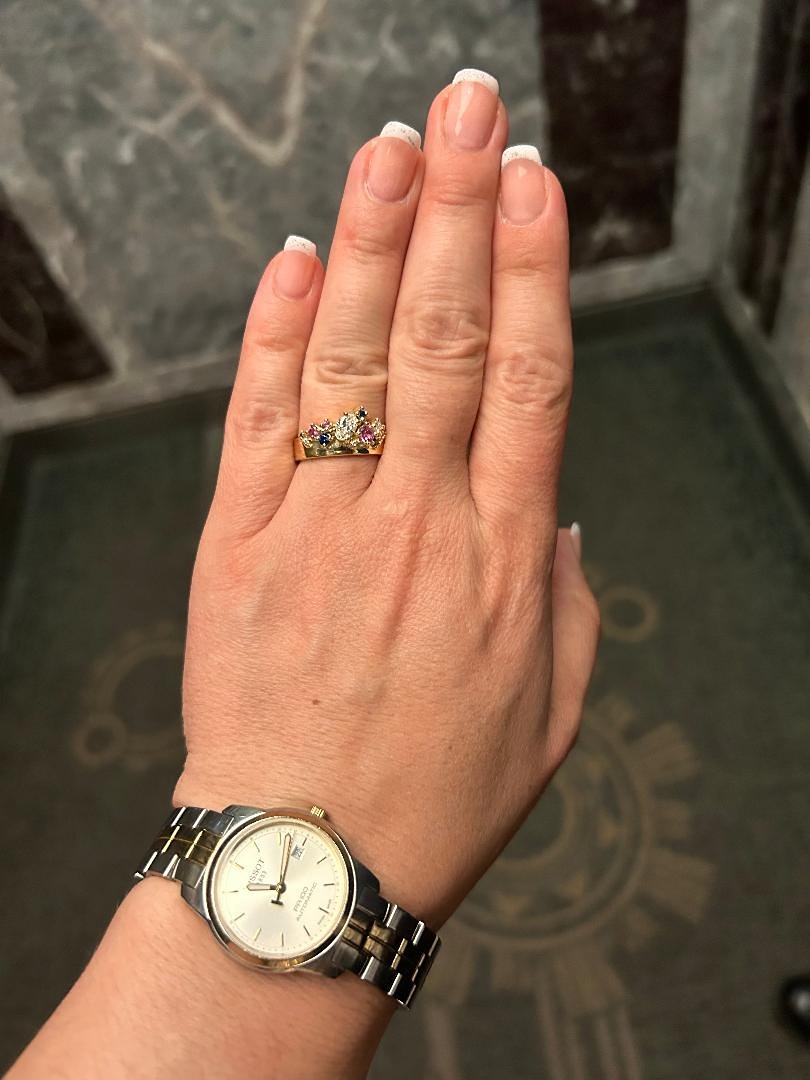 Wide gold band encrusted with diamonds and sapphires