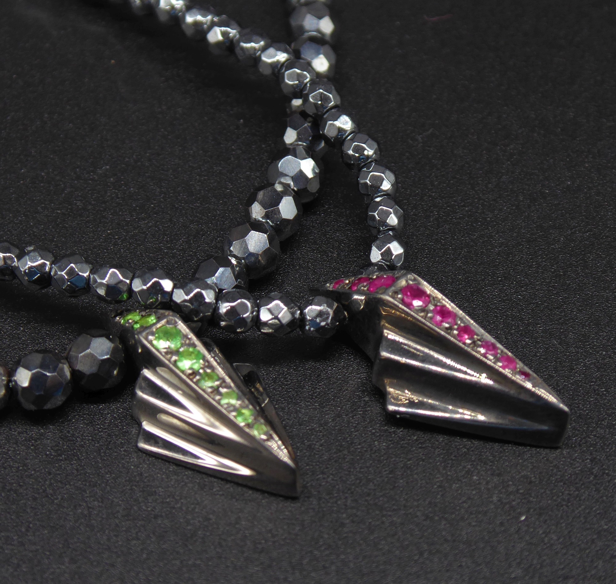 A variety of handmade sterling silver necklaces and artisan pendants on display.