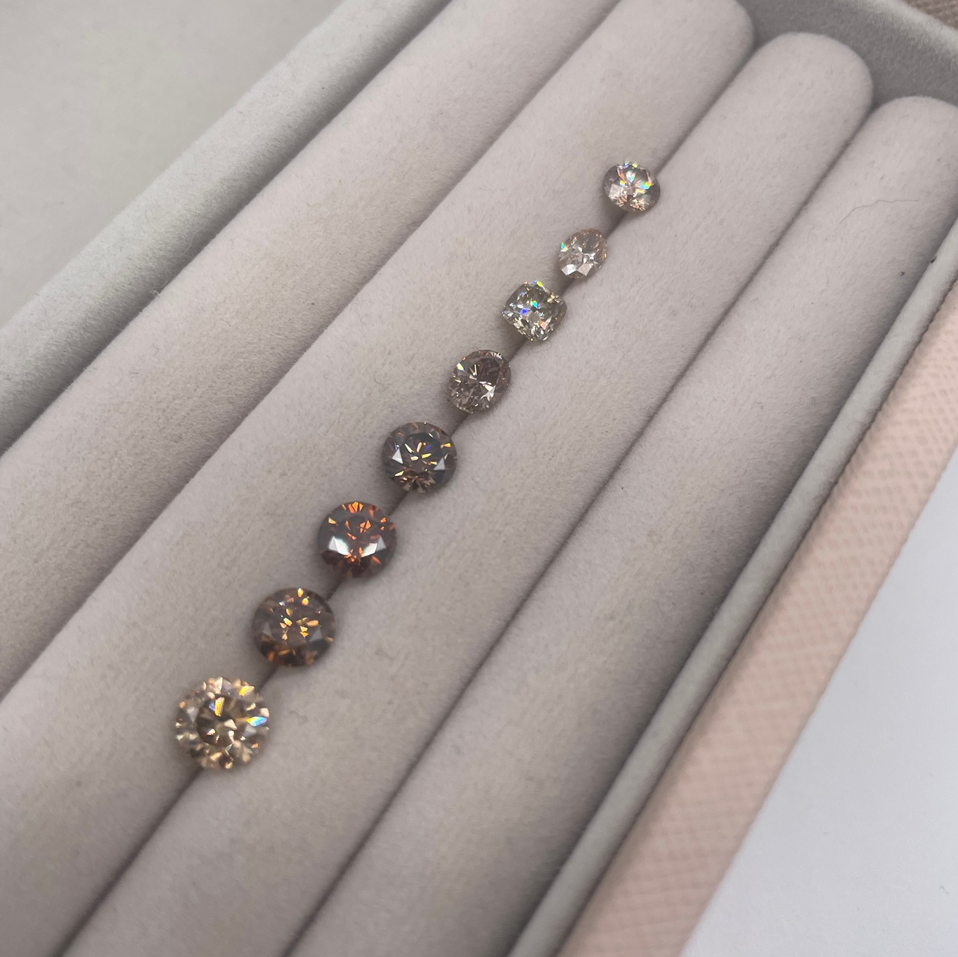 A selection of loose honey champagne diamonds in various cuts, curated for an exclusive 18ct rose gold engagement ring setting in our London studio.