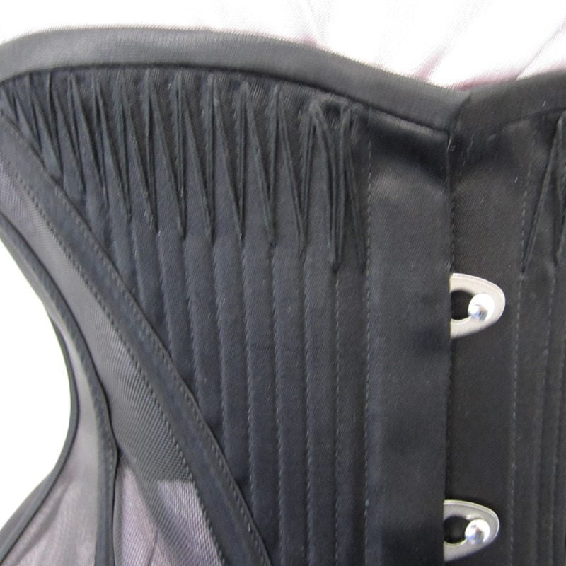 Black corset flossing on a black corset