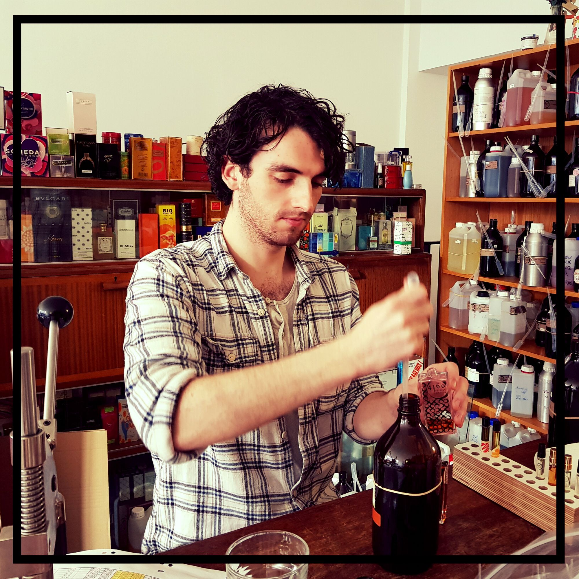 Image of man using pipette to bottle 4160Tuesdays perfume.