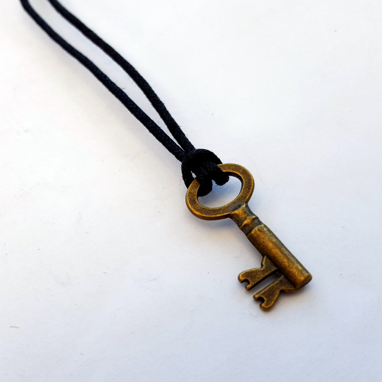 Small bronze key on black cord necklace MN029