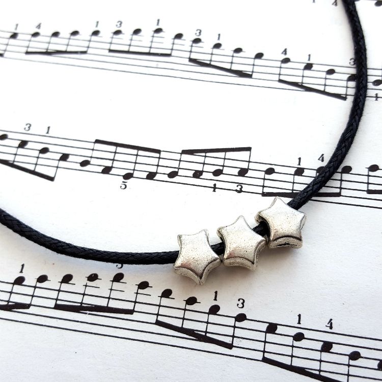Three silver stars necklace on black cord CN100
