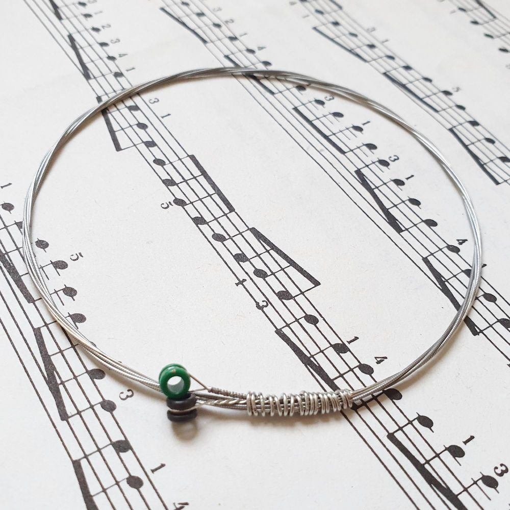 Guitar string bracelet with  black and green ball ends GSB025